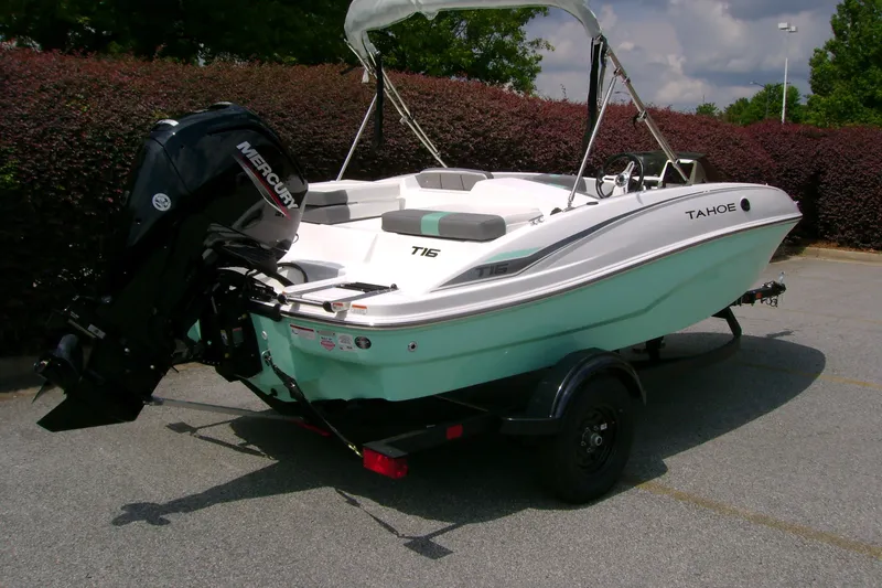 Slide: The Image of 2027 Tahoe T16 boat with Mercury engine on trailer, parked outdoors. - 4