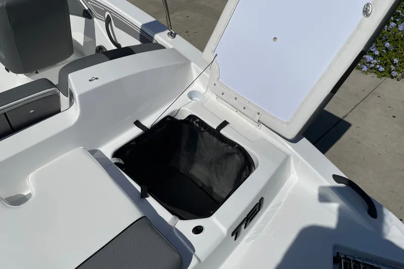 Slide: The Image of Open storage compartment on 2027 Tahoe T21 boat, showcasing interior design and seating. - 28