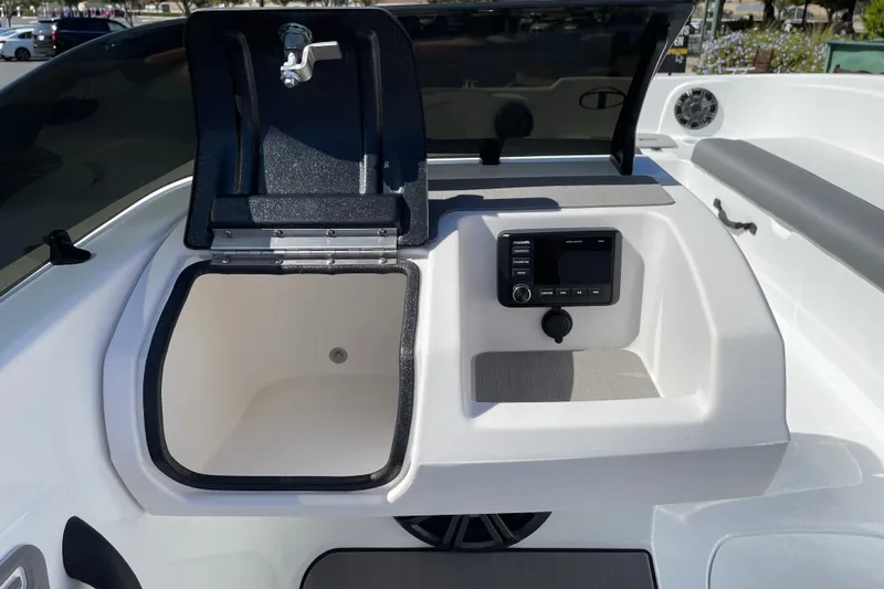 Slide: The Image of 2027 Tahoe T21 boat interior with open storage compartment and control panel. - 19