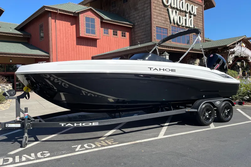 Slide: The Image of 2027 Tahoe T21 boat on trailer outside Outdoor World store. - 2