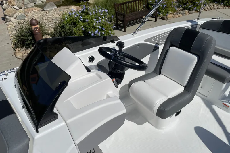 Slide: The Image of 2027 Tahoe T21 boat interior with sleek steering wheel and comfortable seating. - 9