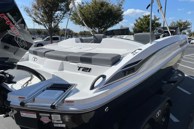 Slide: The Image of 2027 Tahoe T21 boat with Mercury Pro XS engine, parked outdoors on a sunny day. - 5