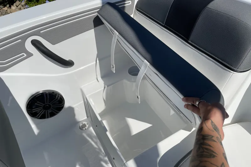 Slide: The Image of 2027 Tahoe T21 boat seat storage compartment with speaker and handle. - 17
