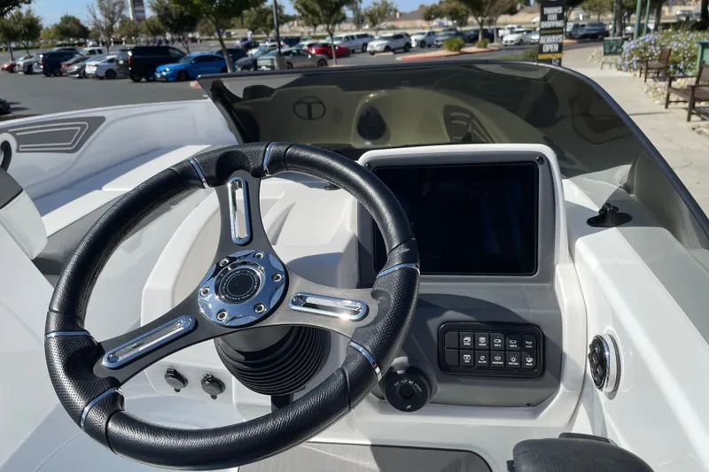 Slide: The Image of Steering wheel and dashboard of 2027 Tahoe T21 boat, featuring modern controls and touchscreen display. - 20