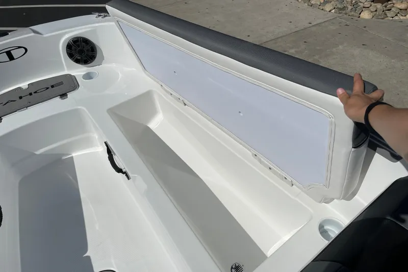 Slide: The Image of 2027 Tahoe T21 boat storage compartment with open seat, showcasing spacious interior design. - 23