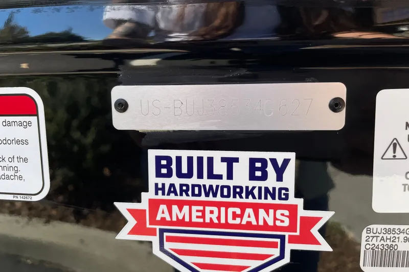 Slide: The Image of 2027 Tahoe T21 with 'Built by Hardworking Americans' sticker and serial number plate. - 117