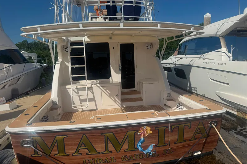 Slide: The Image of 2003 Bertram 450 Convertible yacht docked, featuring "Mamita" name and Coral Gables, FL location. - 3