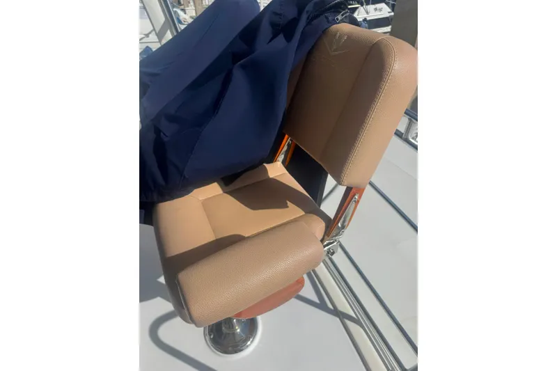 Slide: The Image of Captain's chair on 2003 Bertram 450 Convertible yacht, covered with a navy blue cloth. - 13