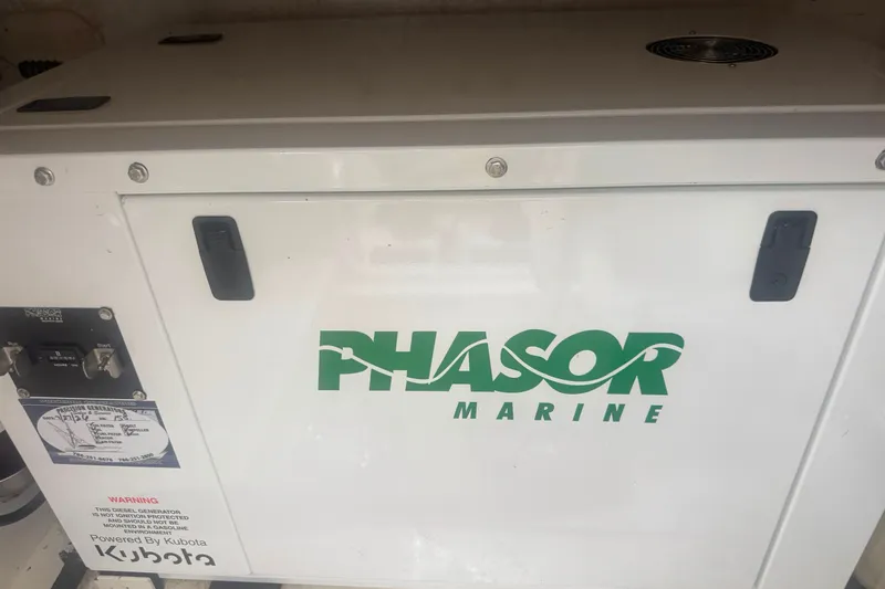 Slide: The Image of Phasor Marine generator on a 2003 Bertram 450 Convertible boat, powered by Kubota. - 15