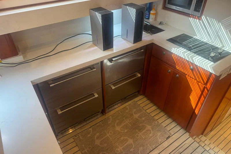 Slide: The Image of Kitchen area of a 2003 Bertram 450 Convertible yacht with modern appliances. - 8