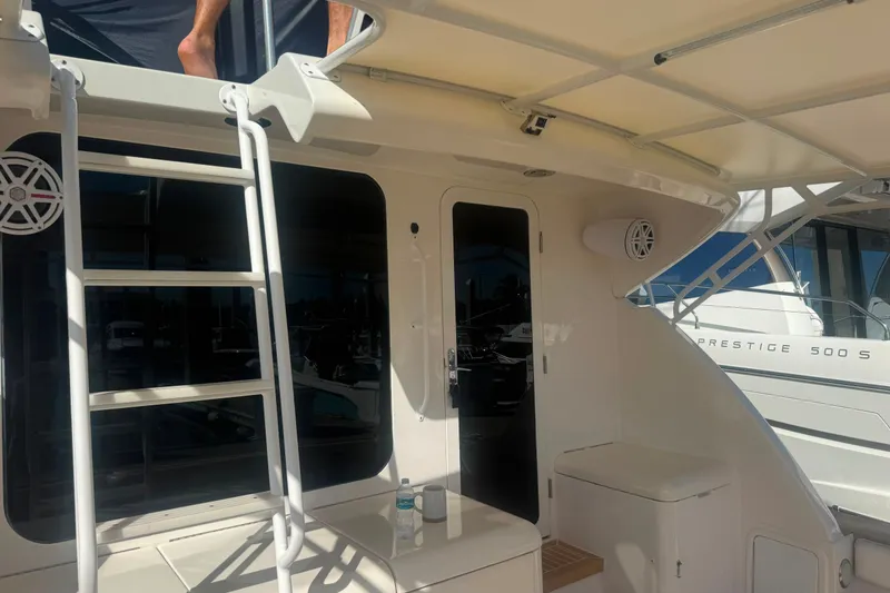Slide: The Image of 2003 Bertram 450 Convertible yacht deck with ladder and seating area. - 10