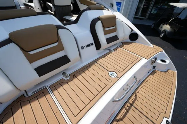Slide: The Image of 2022 Yamaha 212 boat with tan and white seating, teak-style deck. - 18