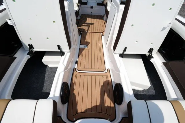Slide: The Image of 2022 Yamaha 212 boat interior with teak-style flooring and white seating. - 10