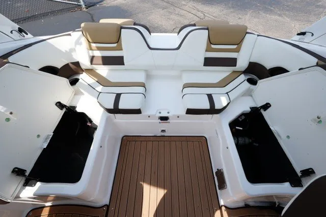 Slide: The Image of 2022 Yamaha 212 boat interior with cushioned seating and open storage compartments. - 17