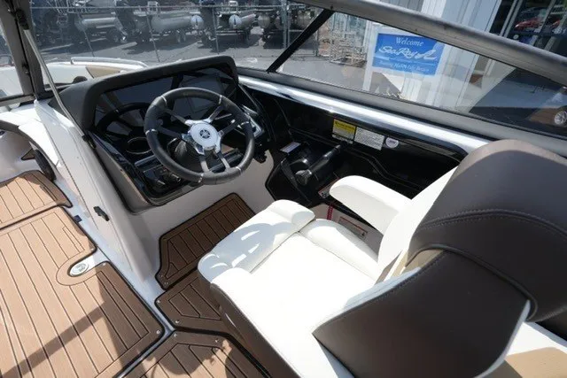 Slide: The Image of Interior of 2022 Yamaha 212 boat with steering wheel and seating. - 13