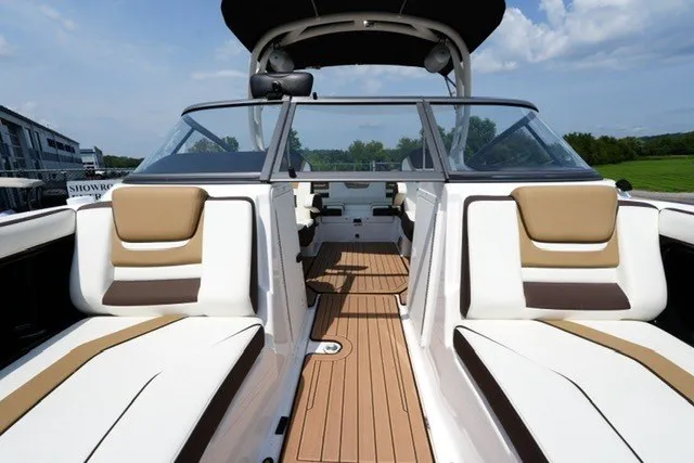 Slide: The Image of 2022 Yamaha 212 boat interior with tan and white seating, open deck view. - 11