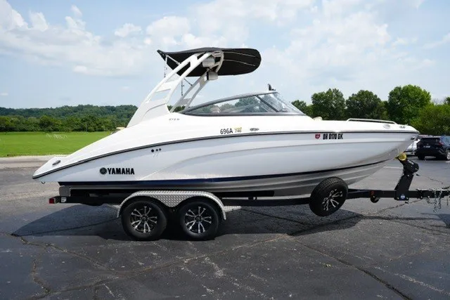 Slide: The Image of 2022 Yamaha 212 boat on trailer, sleek design, parked outdoors on a sunny day. - 4