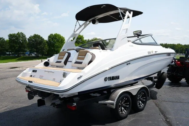 Slide: The Image of 2022 Yamaha 212 boat on trailer, sleek design, white exterior, outdoor setting. - 5