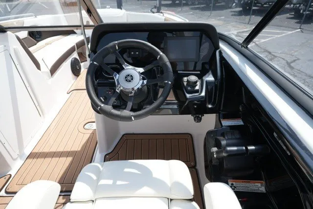 Slide: The Image of 2022 Yamaha 212 boat cockpit with steering wheel and modern dashboard controls. - 14