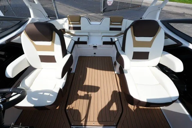 Slide: The Image of 2022 Yamaha 212 boat interior with white and brown seating, wood-style flooring. - 15