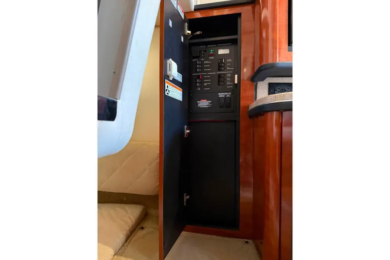 Slide: The Image of Electrical panel inside 2007 Sea Ray Sundancer 260 boat cabin, featuring control switches. - 15