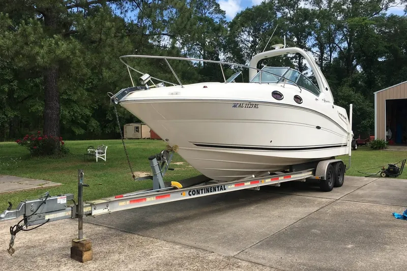 Slide: The Image of 2007 Sea Ray Sundancer 260 boat on trailer in a wooded area. - 1