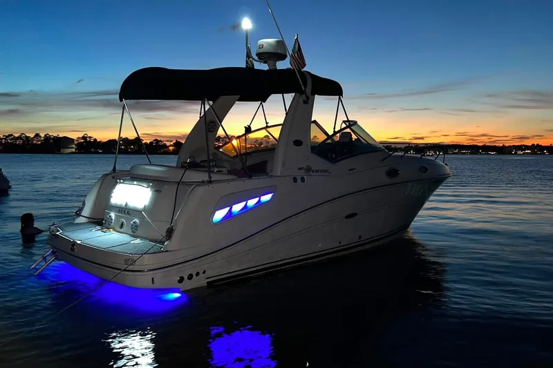 Slide: The Image of 2007 Sea Ray Sundancer 260 boat illuminated at sunset on calm waters. - 6