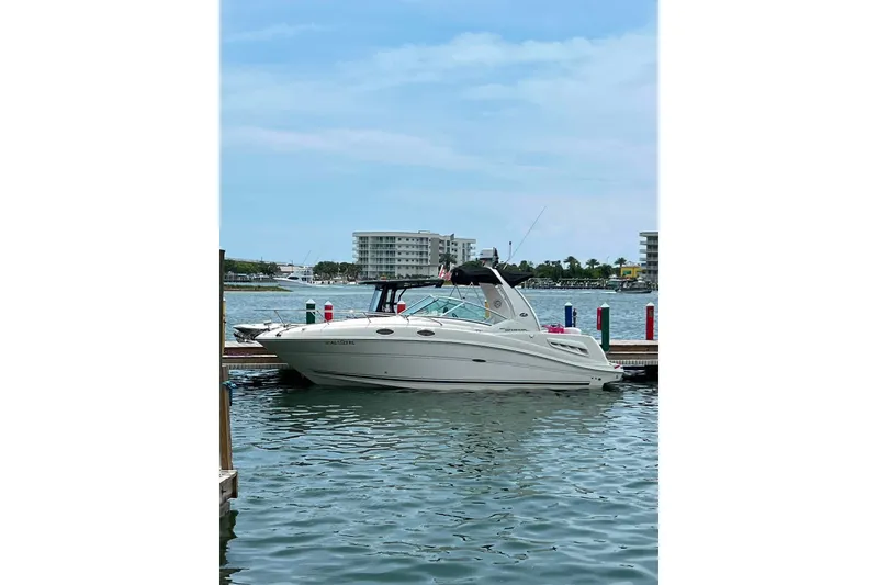 Slide: The Image of 2007 Sea Ray Sundancer 260 docked in a marina with waterfront buildings. - 4