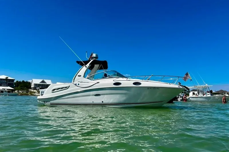 The Image of 2007 Sea Ray Sundancer 260 boat anchored in clear water under a bright blue sky. - 0