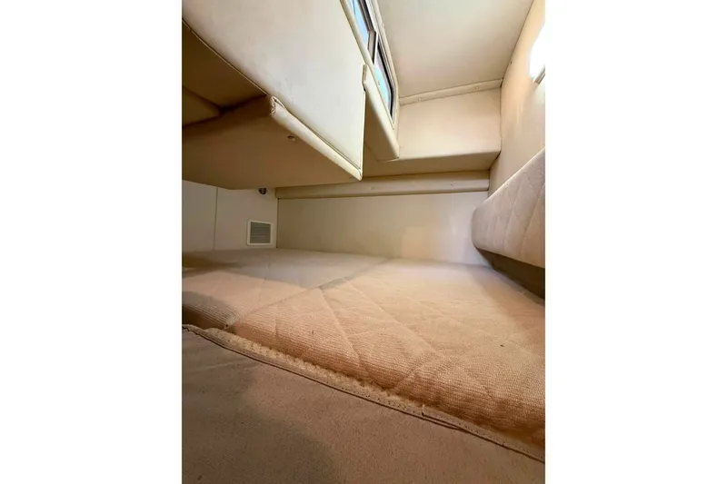 Slide: The Image of Interior cabin of 2007 Sea Ray Sundancer 260, featuring cozy sleeping area. - 16