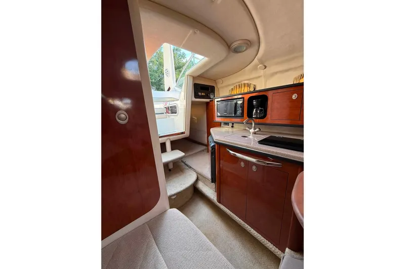 Slide: The Image of Interior of 2007 Sea Ray Sundancer 260, featuring kitchenette with microwave and sink. - 14