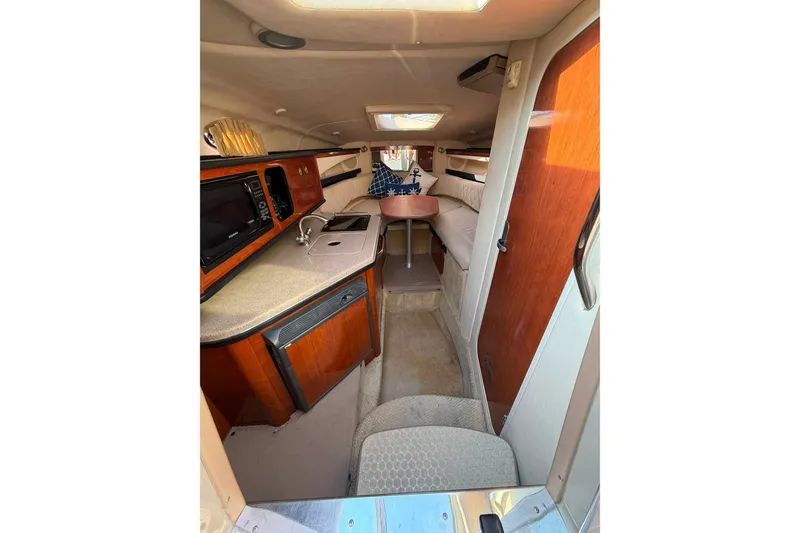 Slide: The Image of 2007 Sea Ray Sundancer 260 cabin interior with kitchenette and seating area. - 11