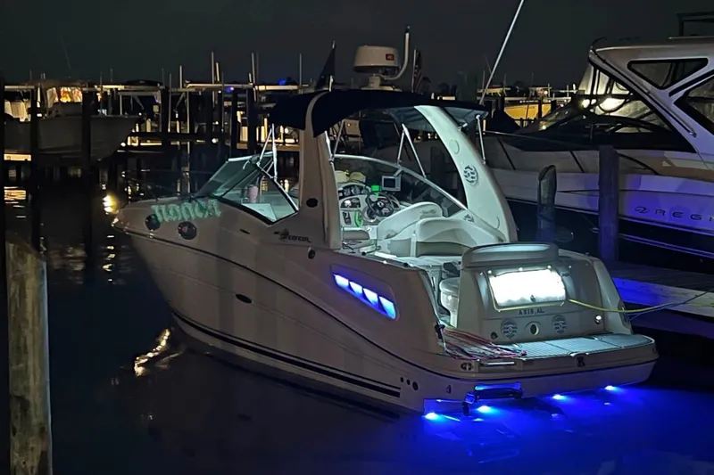 Slide: The Image of 2007 Sea Ray Sundancer 260 boat docked at night with blue underwater lights. - 7