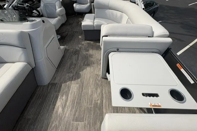 Slide: The Image of 2022 Crest CLASSIC FISH 220SF boat interior with gray seating and wood-style flooring. - 10
