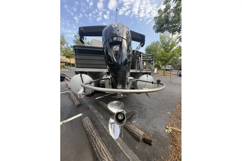 Slide: The Image of 2022 Crest Classic Fish 220SF boat with outboard motor in a parking lot. - 5