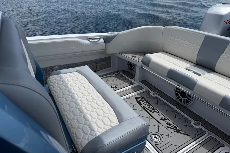 Slide: The Image of 2022 Nor-Tech 340 Sport boat interior with stylish seating and ocean backdrop. - 14