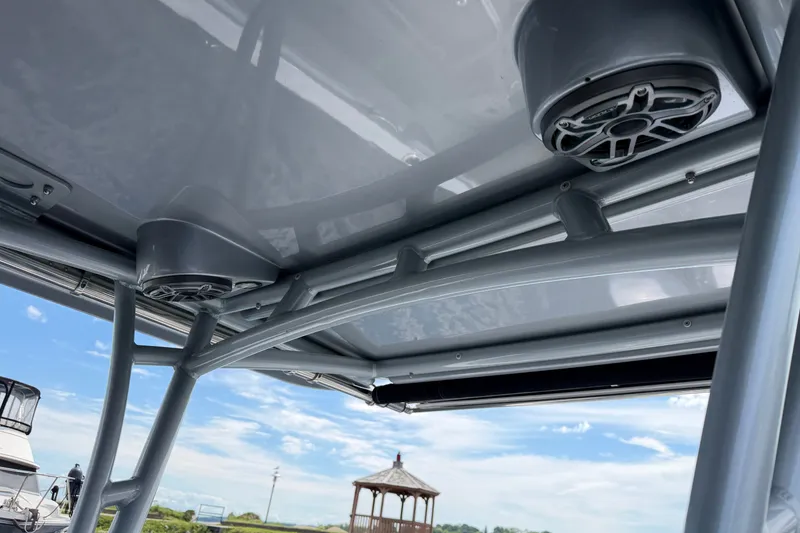 Slide: The Image of 2022 Nor-Tech 340 Sport boat speakers and canopy, with clear blue sky background. - 23