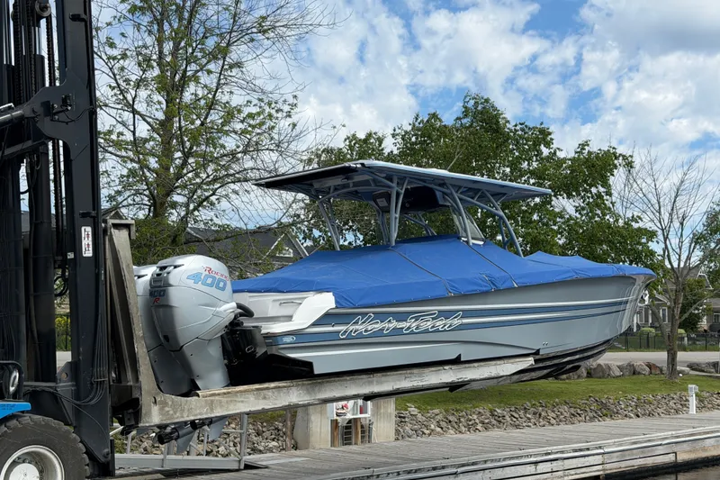 Slide: The Image of 2022 Nor-Tech 340 Sport boat on forklift, covered, with Mercury Racing 400R engine. - 34