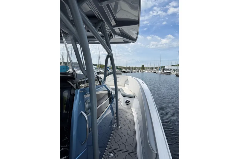 Slide: The Image of 2022 Nor-Tech 340 Sport boat docked at marina, showcasing sleek design and spacious deck. - 30