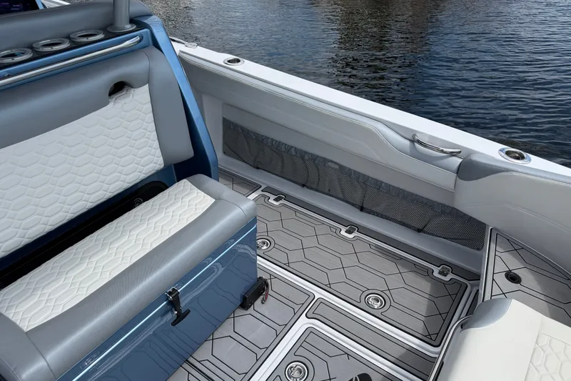 Slide: The Image of 2022 Nor-Tech 340 Sport boat interior with stylish seating and modern flooring design. - 16