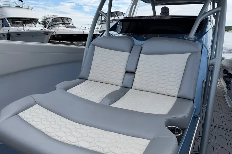 Slide: The Image of Luxury seating on 2022 Nor-Tech 340 Sport boat, docked with yachts in background. - 26