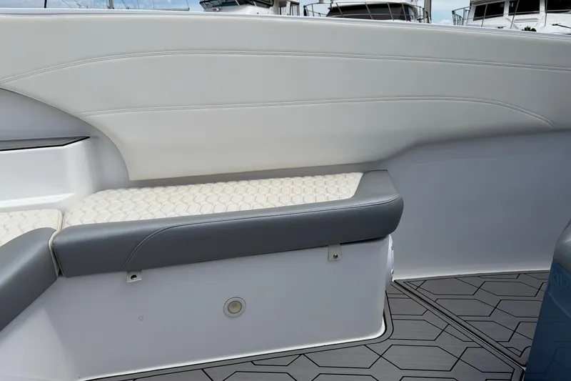 Slide: The Image of 2022 Nor-Tech 340 Sport boat interior with white and gray seating and geometric flooring. - 27