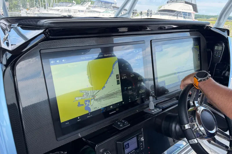 Slide: The Image of Cockpit of 2022 Nor-Tech 340 Sport with dual navigation screens and steering wheel. - 18