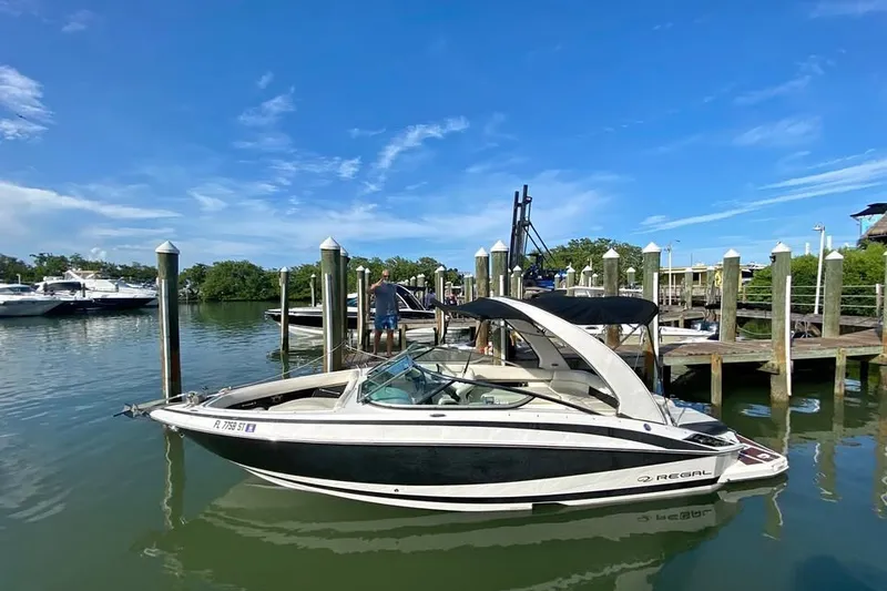 The Image of 2010 Regal 2500 Bowrider docked at marina under clear blue sky. - 0
