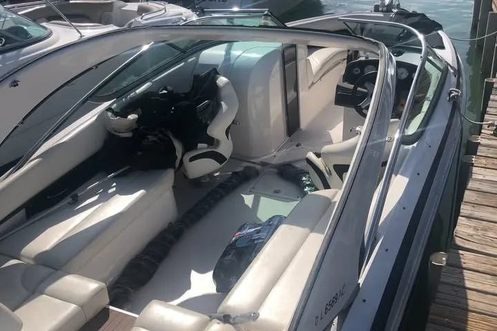 Slide: The Image of 2010 Regal 2500 Bowrider boat docked, featuring spacious seating and sleek design. - 3