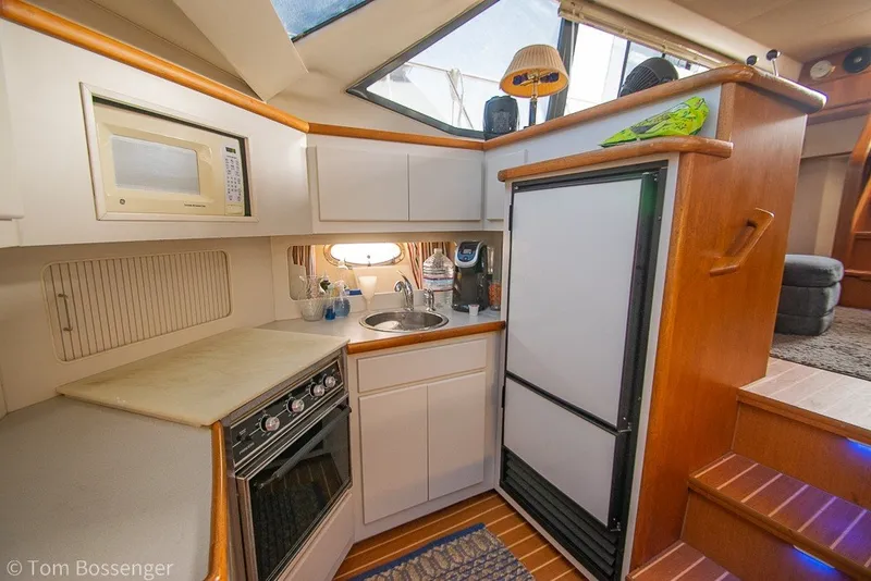 Slide: The Image of Cozy kitchen in 1994 Carver 370 Aft Cabin Motor Yacht with modern appliances. - 18
