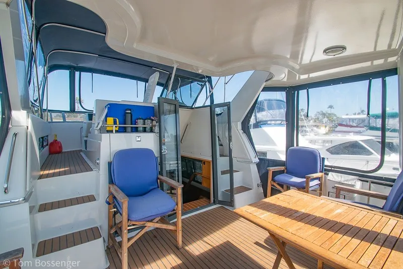 Slide: The Image of 1994 Carver 370 Aft Cabin Motor Yacht interior with seating and wooden table. - 7
