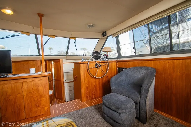 Slide: The Image of Interior of 1994 Carver 370 Aft Cabin Motor Yacht with helm and seating area. - 14