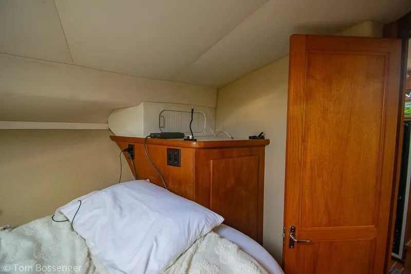 Slide: The Image of Cozy cabin interior of 1994 Carver 370 Aft Cabin Motor Yacht with wooden cabinetry. - 30