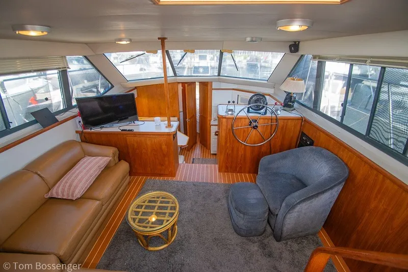 Slide: The Image of Interior of 1994 Carver 370 Aft Cabin Motor Yacht with cozy seating and helm. - 9